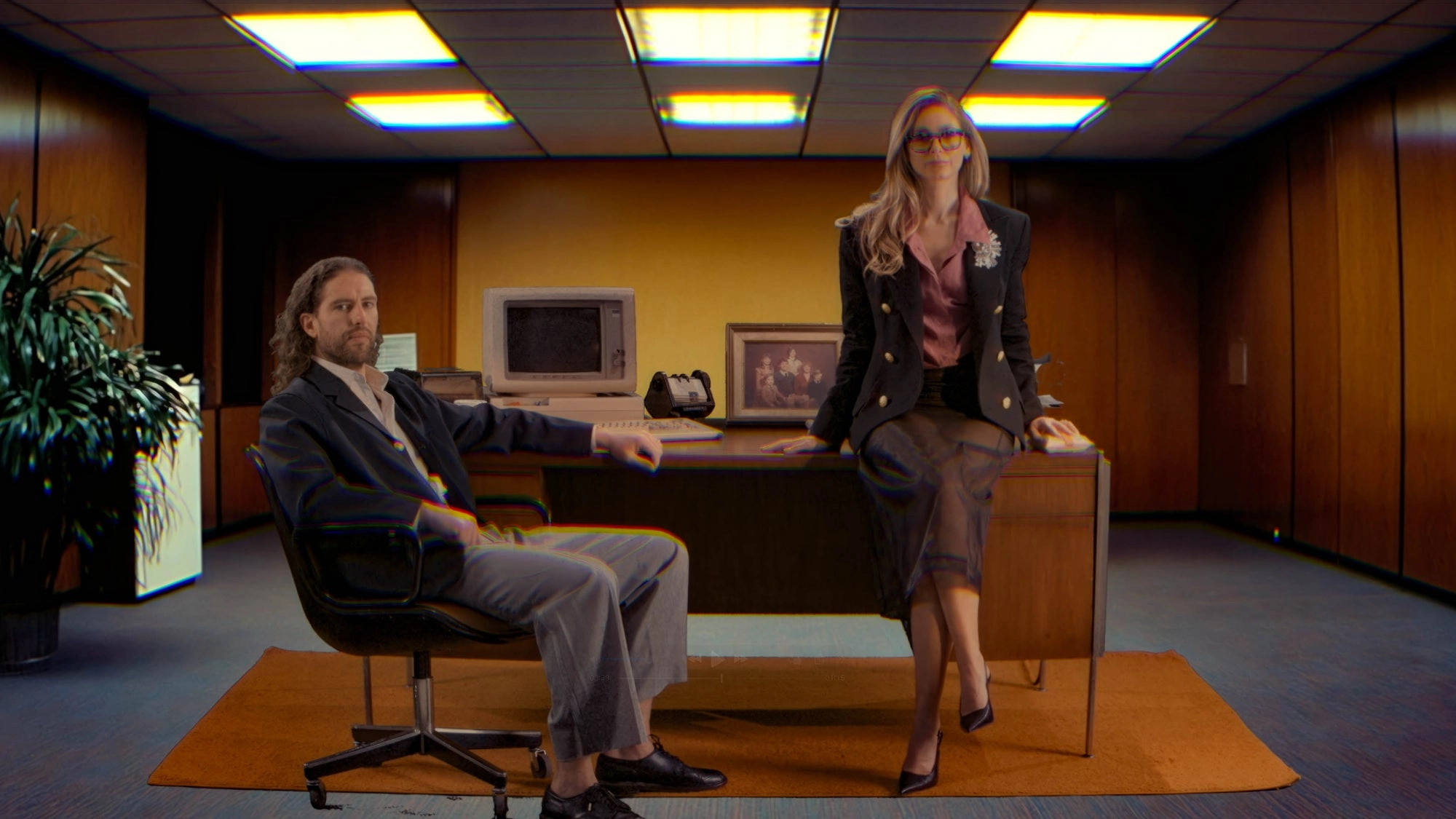 Two people in a office setting with a computer and desk. Joshua Katz and Carli Roth founders of Norms Hemorrhoid Treatment company